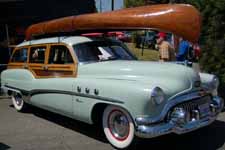 Restored 1928 Willits Brothers wood canoe and accessories on 1951 Buick Estate Wagon roof rack
