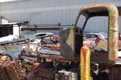 1950's truck cab and acres of original parts for vintage cars and trucks in old car salvage yard