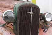 Nice original vintage radiator and trim on 1936 Chevy truck in vintage car junk yard